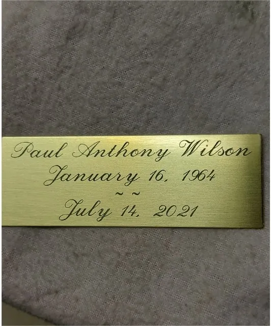 Finished brass memorial plaque engraved in script