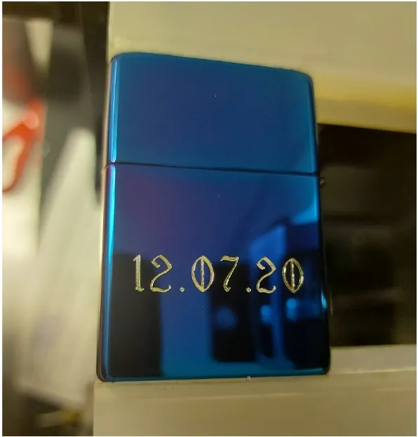 Blue Zippo lighter engraved with an anniversary date