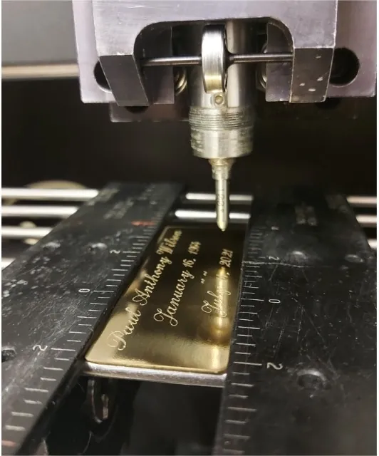 Rotary needlepoint engraving a brass memorial plaque in our Hamilton studio